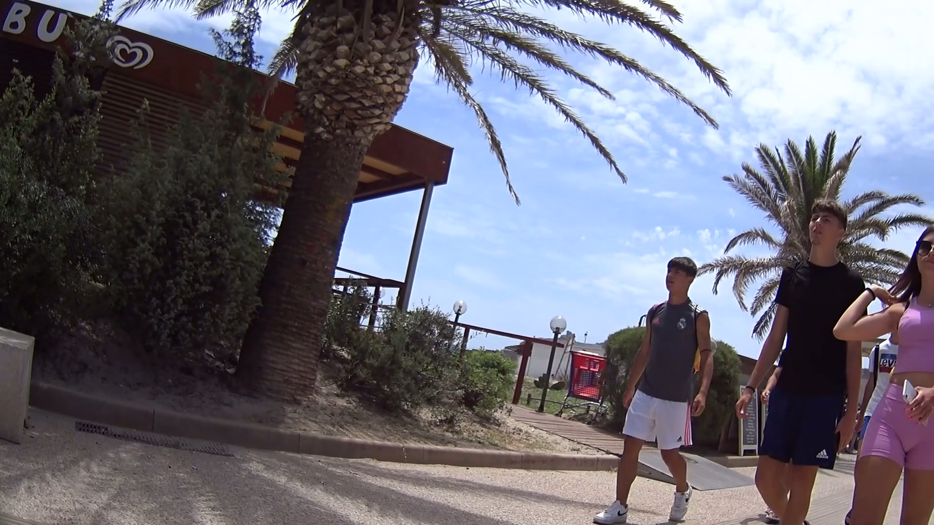Perfect teen in pink shorts goes to the beach