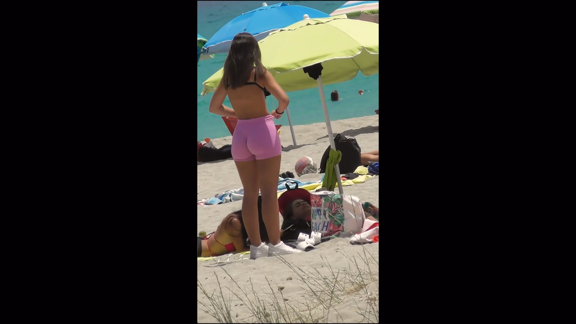 Perfect teen in pink shorts goes to the beach